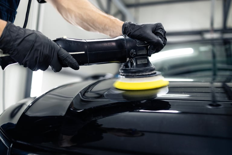 Close up view of vehicle polisher tool rotating and polishing car hood